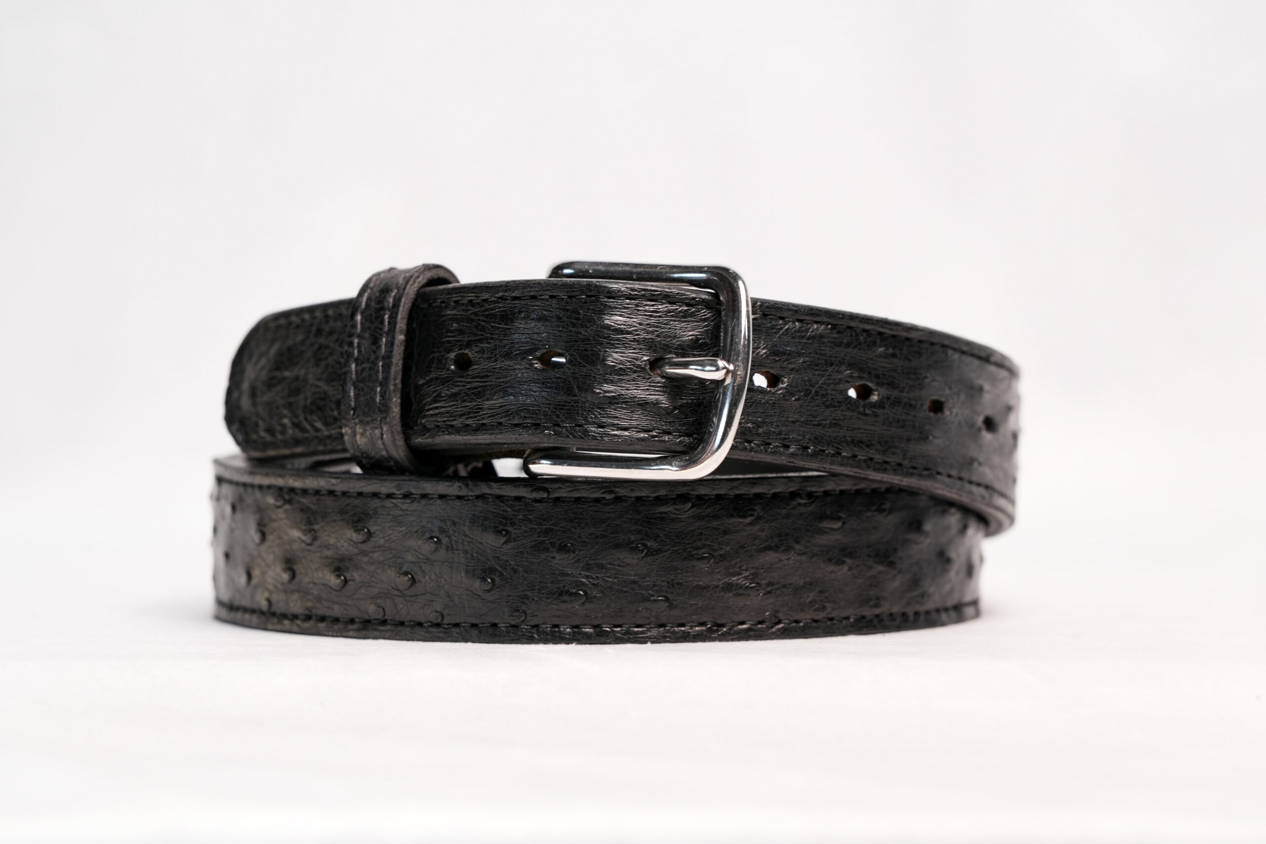 Stainless steel buckle on black ostrich leather belt
