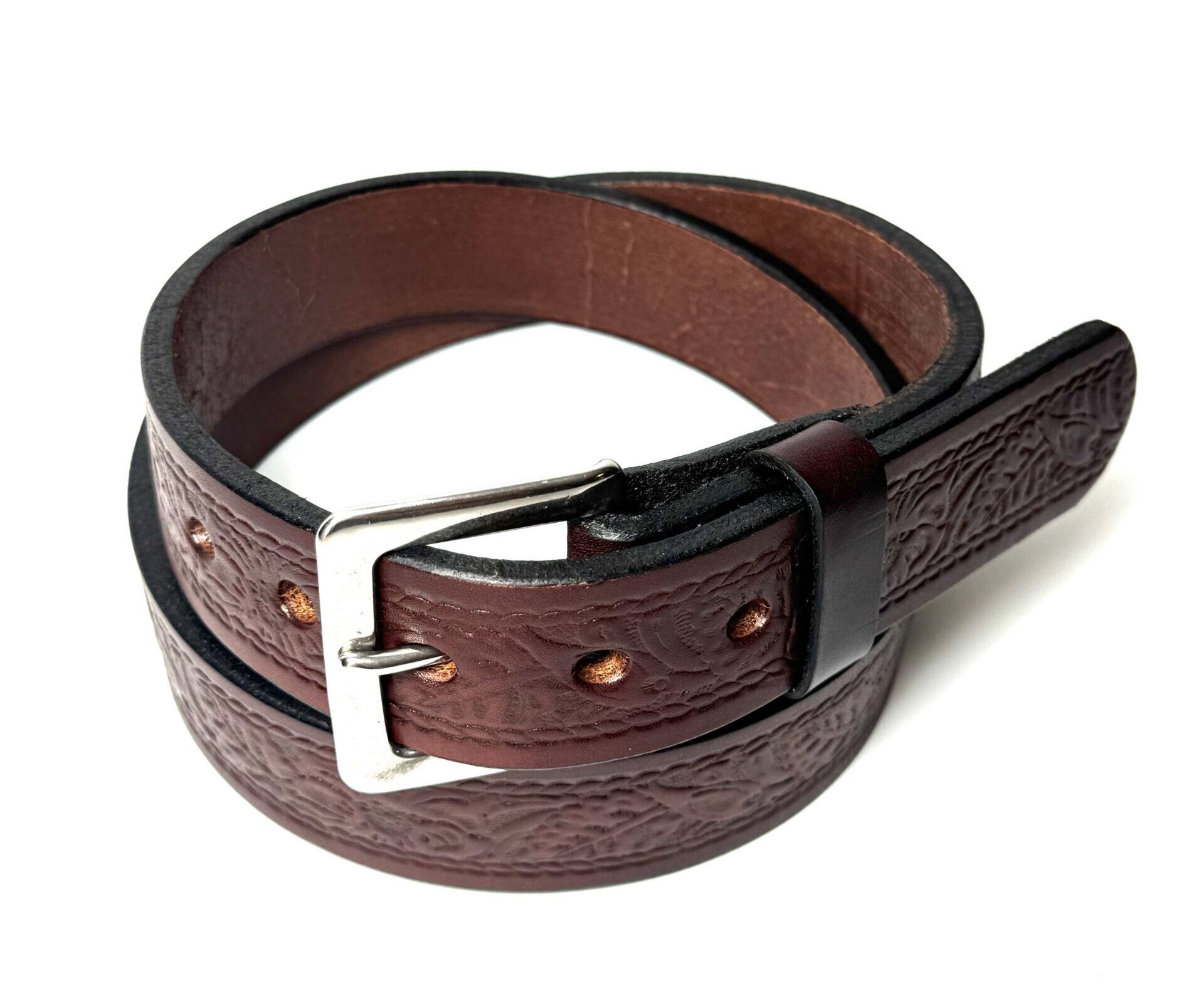 Close-up of floral tooling on brown full-grain leather belt