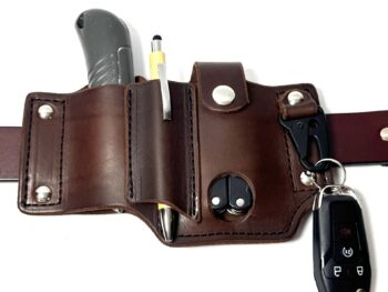Brown leather EDC belt organizer holding a folding knife, pen, multi-tool, and keys