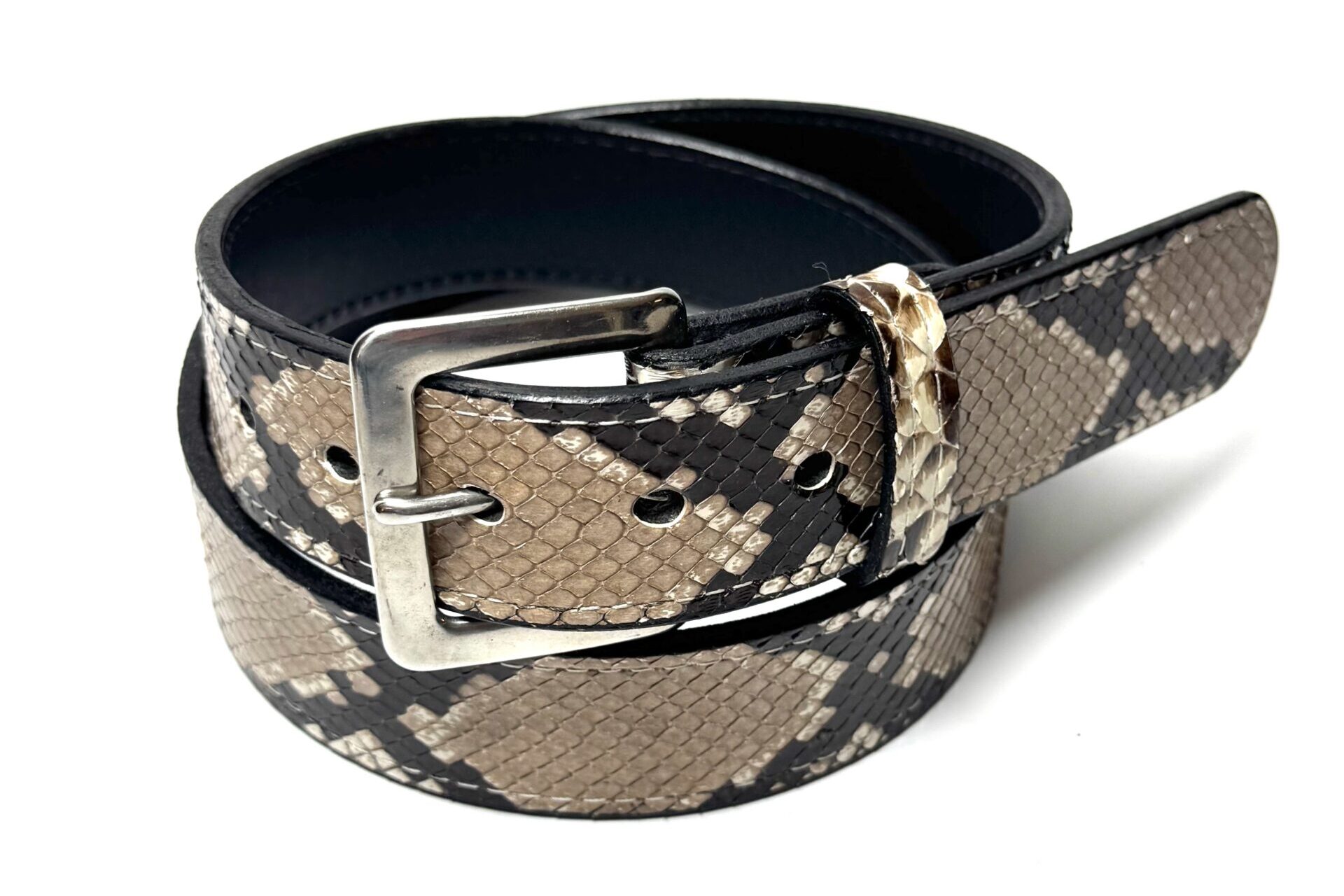 Close view of natural python scales on handcrafted leather belt