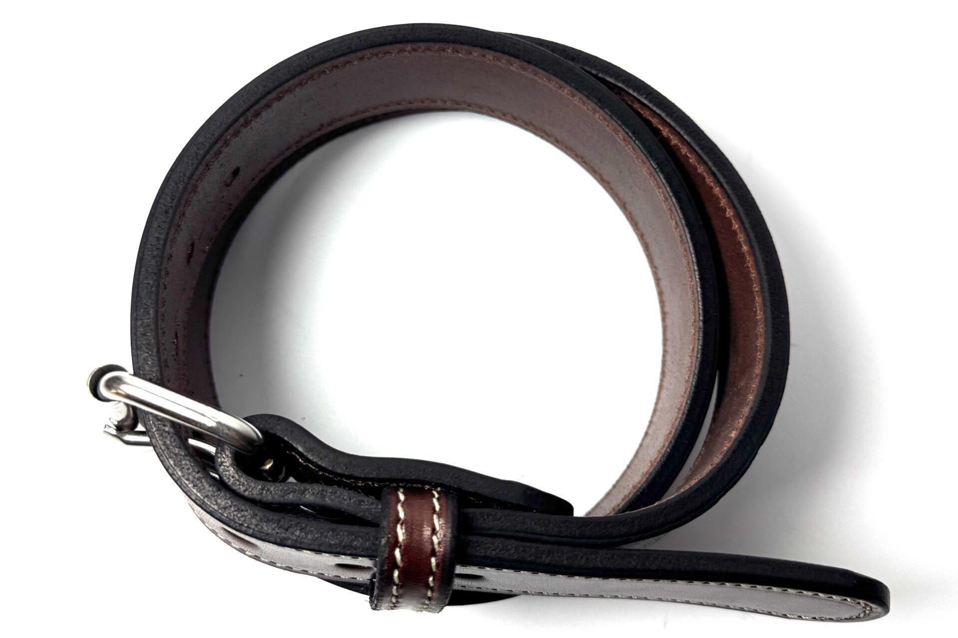Top view of white stitched brown heavy cowhide leather belt