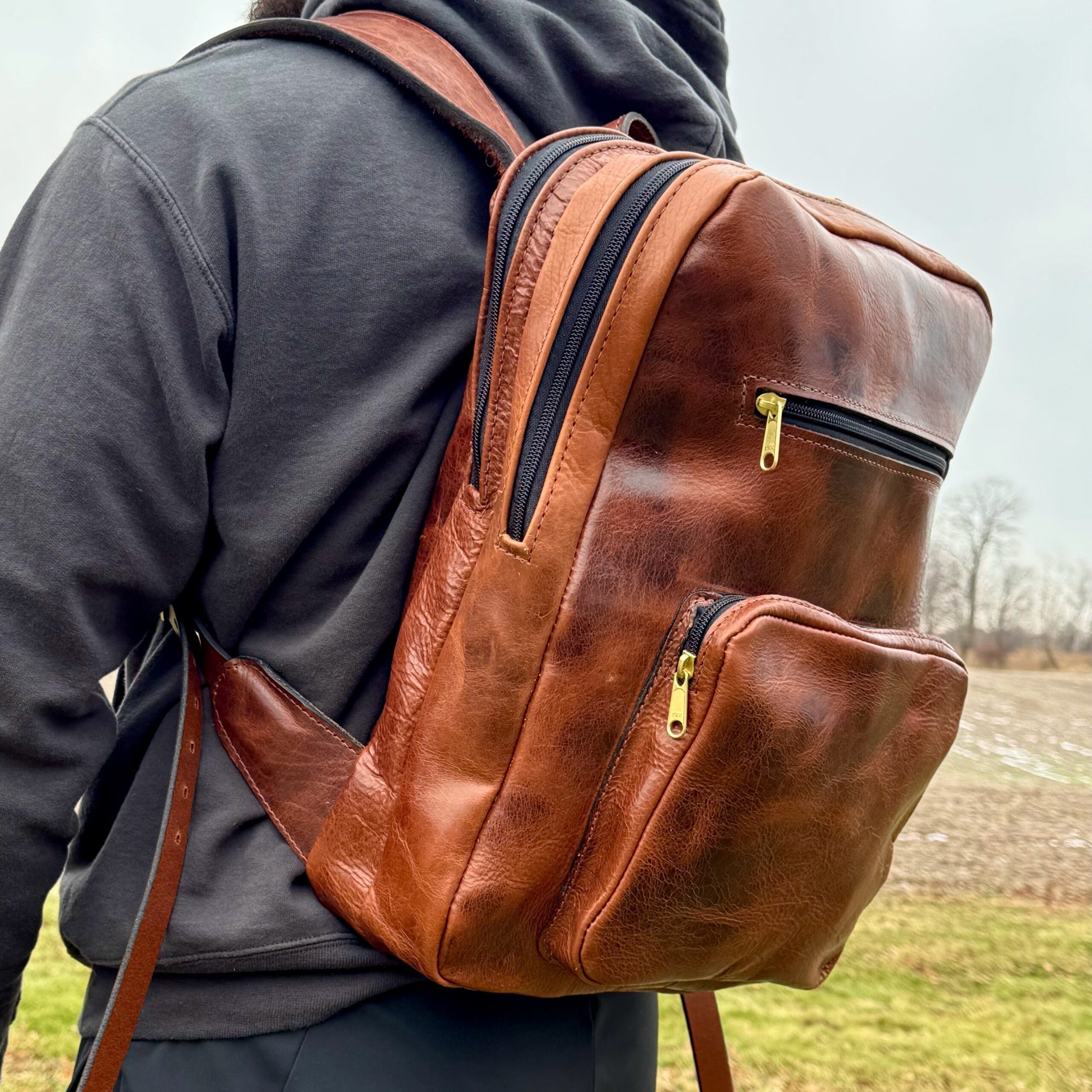 Brown American Bison leather backpack being worn outdoors