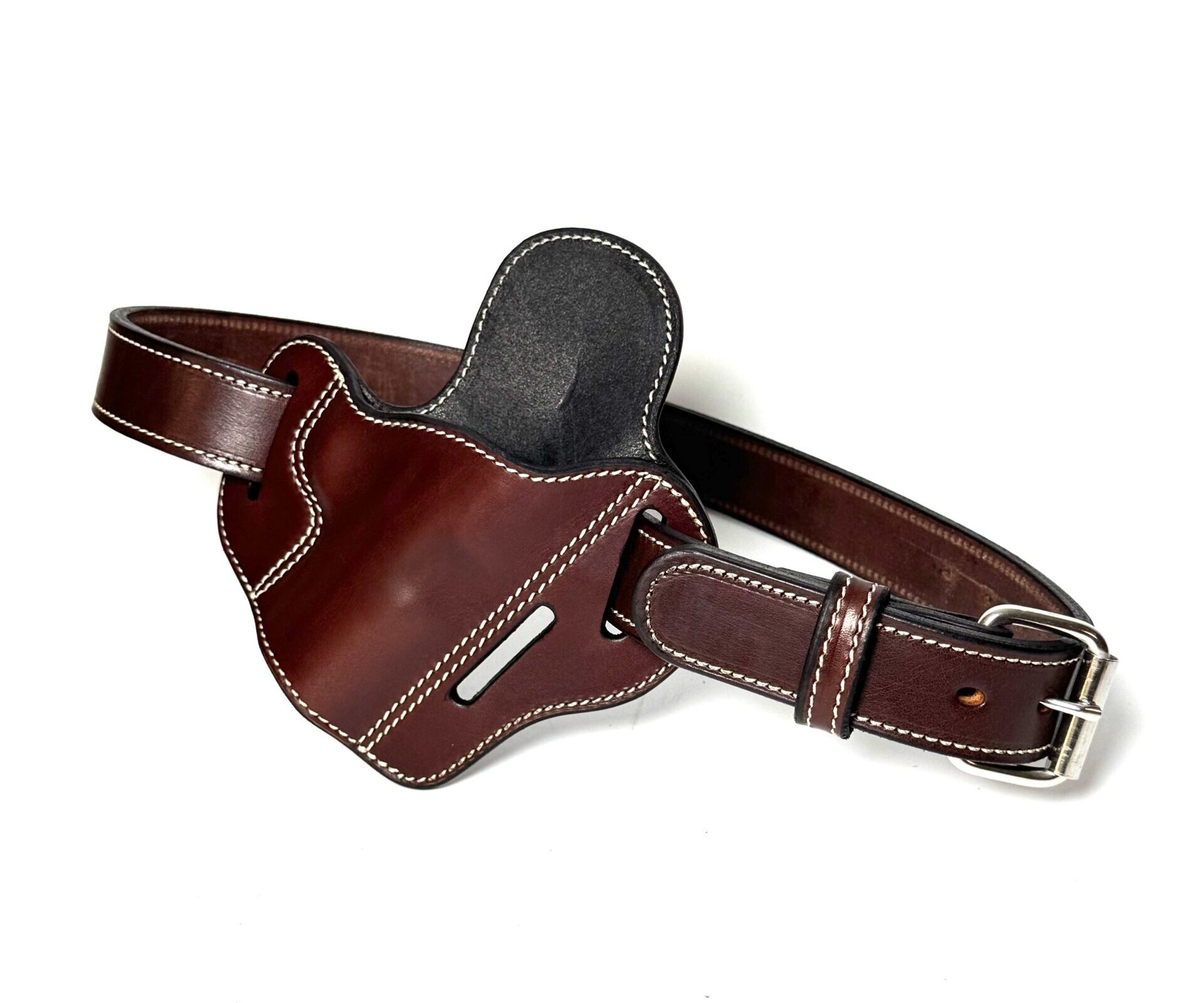 Angled view of brown 1911 holster and matching belt with white stitching