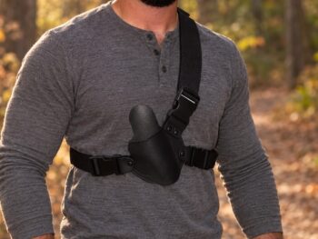Black water buffalo leather chest holster with adjustable nylon harness worn across chest