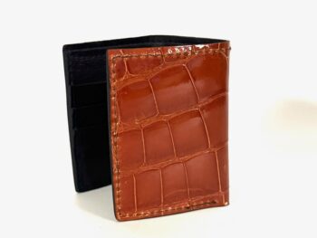 Natural scale pattern on cognac alligator trifold wallet